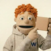 Carl holding a plain product box