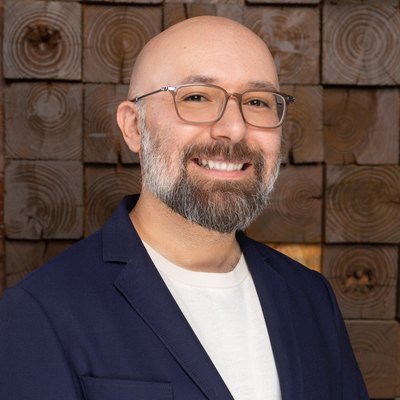 Tony Castillo, founder of WISLR.ai, beside his name and the WISLR.ai lockup on a press sheet