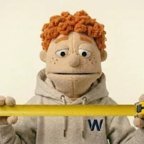 Carl holding a yellow measuring stick