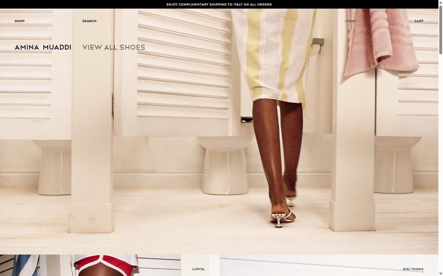 Amina Muaddi homepage on desktop, Shopify luxury footwear storefront captured at 1440 x 900